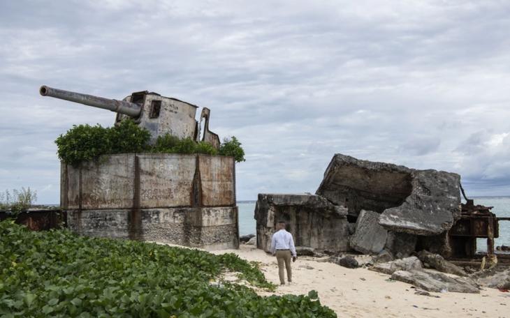 A U.S. Marine walks towards a weapon used during the Battle of Tarawa during World War II at Tarawa, Kiribati on July 17, 2019. Along with participating in the Repatriation Ceremony for the possible remains of U.S service members that were brought back to the United States, Marines were also given a tour of the Island and taught of the history of the Battle of Tarawa. (U.S. Marine Corps photo by Cpl. Taryn Escott)