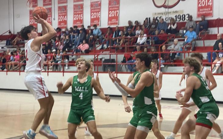 Miles Bulldog Cooper Ellison goes to make a shot over three Hawks.