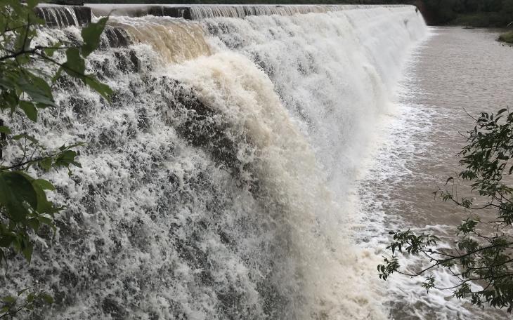 Water from Elm Creek rushes over the dam at Ballinger's City Park on Tuesday, Sept. 3, 2024, after heavy rains in the area.