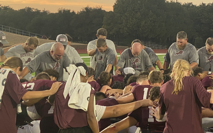 The 2024 Brownwood Lions pray after their scrimmage against Argyle Liberty Christian