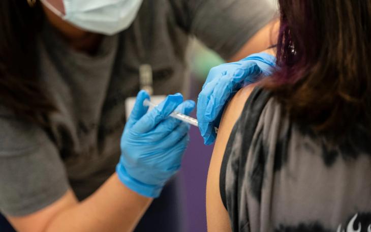 A nurse administers a dose of the Pfizer COVID vaccine at a clinic organized by the Travis County Mobile Vaccine Collaborative at Rodriguez Elementary School on July 28, 2021.