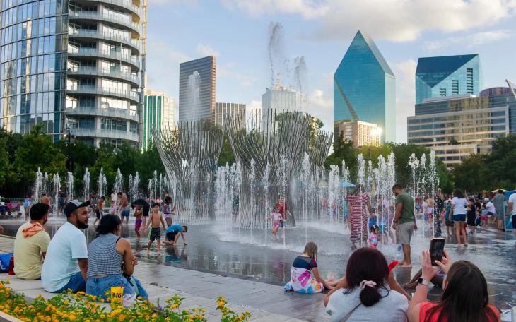Children play at the Nancy Best Fountain at Klyde Warren Park in downtown Dallas on July 27. The City Council voted this week to end diversity initiatives to keep federal funding.