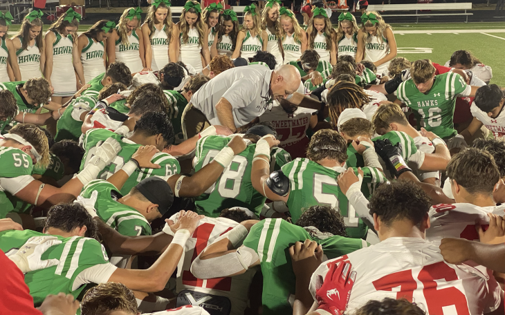 Wall Hawk Head Coach Craig Slaughter leads the teams in prayer