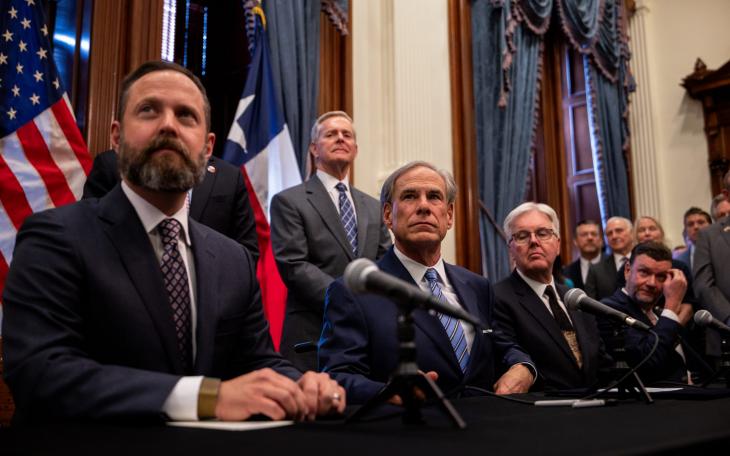 From left, House Speaker Dustin Burrows, Gov. Greg Abbott and Lt. Gov. Dan Patrick hold a bill signing ceremony at the Texas Capitol on April 23, 2025 to create a Texas Department of Government Efficiency.