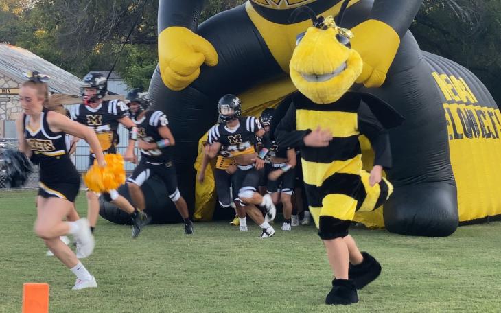 The Menard Yellow Jackets run onto the field before a game against Rocksprings during the 2025 season.