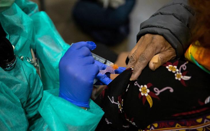 Bessie Bell, 96, receives her first dose of the COVID-19 vaccine at Fair Park, Dallas County's public vaccination site, on Jan. 11, 2021.