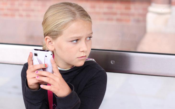 A young girl on her phone (photo courtesy of grandparents.com)