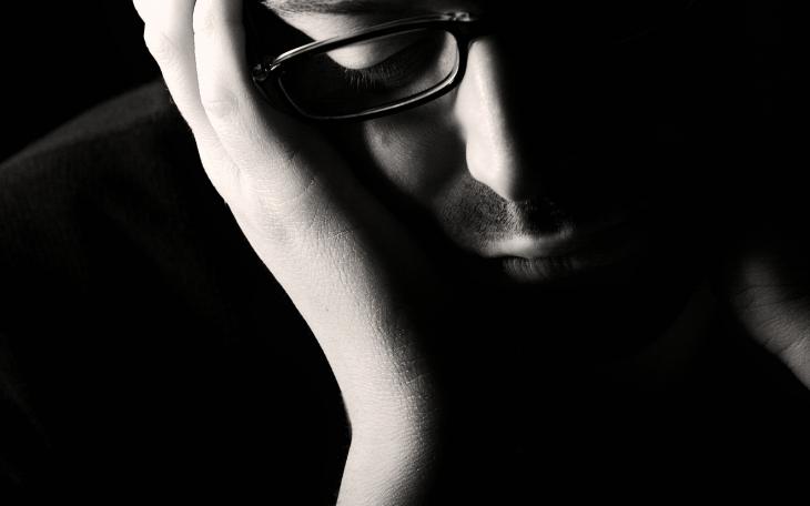 A depressed man with his head in hands (photo courtesy of wellingtonretreat.com)