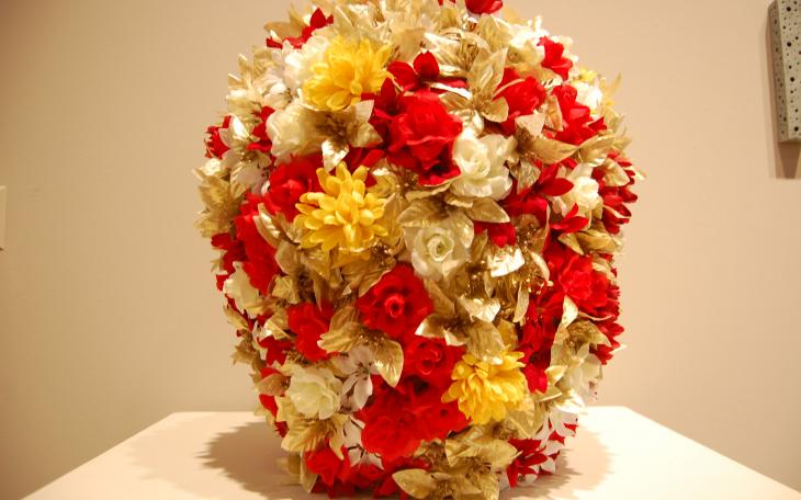 SAMFA patrons had to reach around behind the vase with cell phone cameras to view the imagery Friday, as it was deemed inappropriate for children. (LIVE! Photo/Chelsea Schmid)