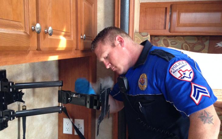 Lake Division Officer James Beddo fingerprints a TV mount after a burglary. (LIVE! Photo by Chelsea Schmid)