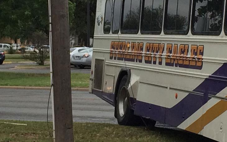 A coach style school bus from Sterling City hit a guy wire near ASU Tuesday. (LIVE! Photo/John Basquez)