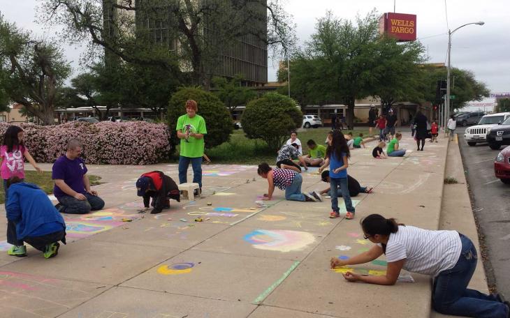 Sidewalk chalk artists of all ages were scattered throughout the courtyard and sidewalks surrounding the courthouse busily creating masterpieces Apr. 11, 2015. (LIVE! Photo/Amanda Henson)
