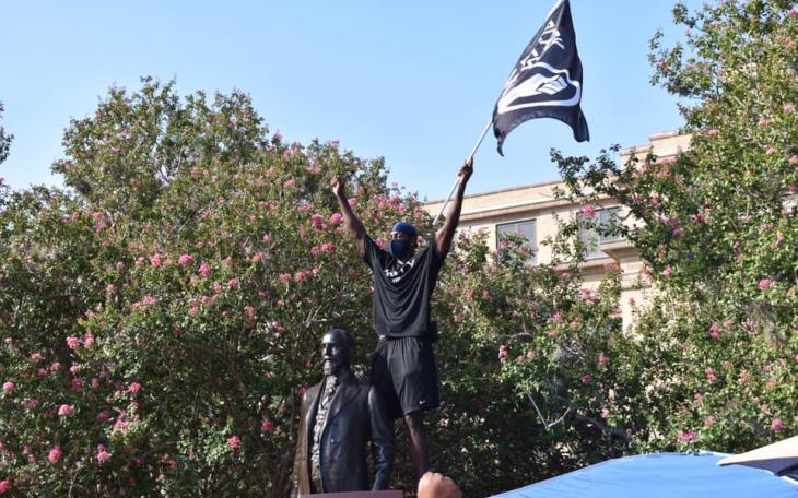 In July 2020, Infinite Tucker, a scholarship track athlete at Texas A&amp;M, rises in protest over the statue of Lawrence Sullivan Ross, 1838-1898. Soldier, Statesman, Knightly Gentleman. Brigadier General, CSA. President of the A&amp;M College.