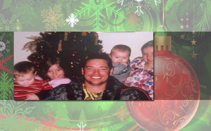 Brandon Lawson smiles with his children before their Christmas tree. (Photo courtesy of Facebook)