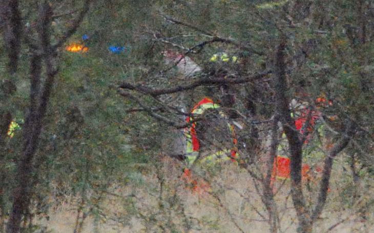 Rescue workers extracting the victim from the wreckage, about 50 yards into a Mesquite-covered field. (LIVE! Photo/Dylan Underwood)