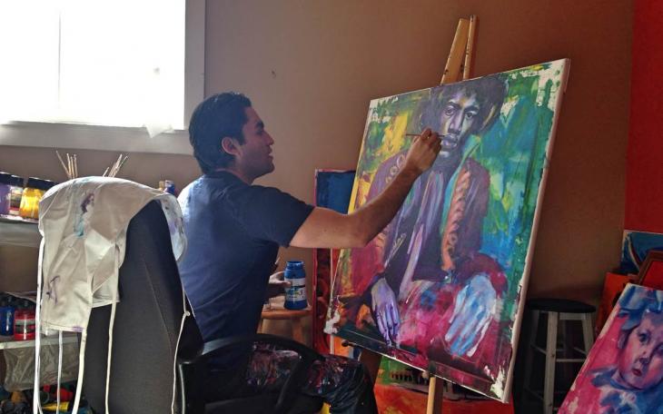 Alejandro Castanon works on a Jimi Hendrix portrait in his studio. (LIVE! Photo by Chelsea Schmid)