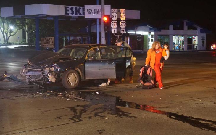 A driver grabs her belongings from a gray chevy Malibu that was involved in a crash on Abe at Beauregard on Feb. 21, 2015. (LIVE! Photo/John Basquez)