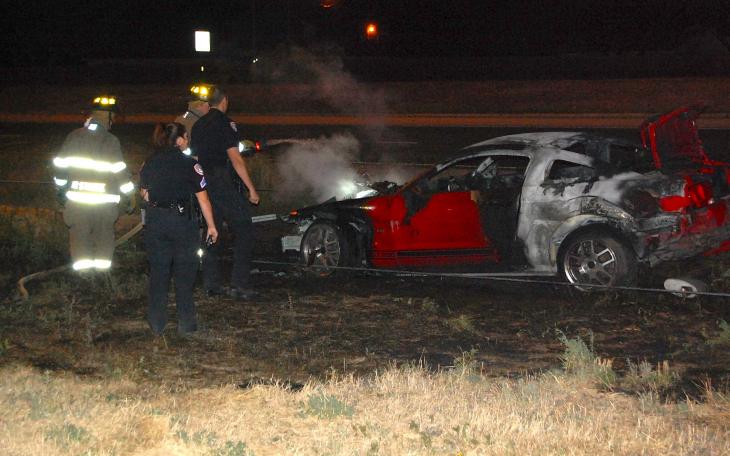 A woman driving a red Ford Mustang 500 GT spins out of control, crashes, and gets trapped inside burning vehicle. (LIVE! Photo/Joe Hyde)