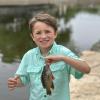 Kid caught a fish at fishing derby 