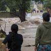 Onlookers gather on both sides as floodwaters swallow East Lane Valley Road in Comfort, Texas, on July 16, 2026. Heavy rainfall pushed the Guadalupe River out of its banks across the Hill Country. 
