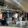 American Airlines passengers wait in a TSA security line at Dallas Fort Worth International Airport, Dec. 18, 2022. 
