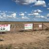 Protest signs near the proposed Beacon Data Centers project site in southwest Tom Green County