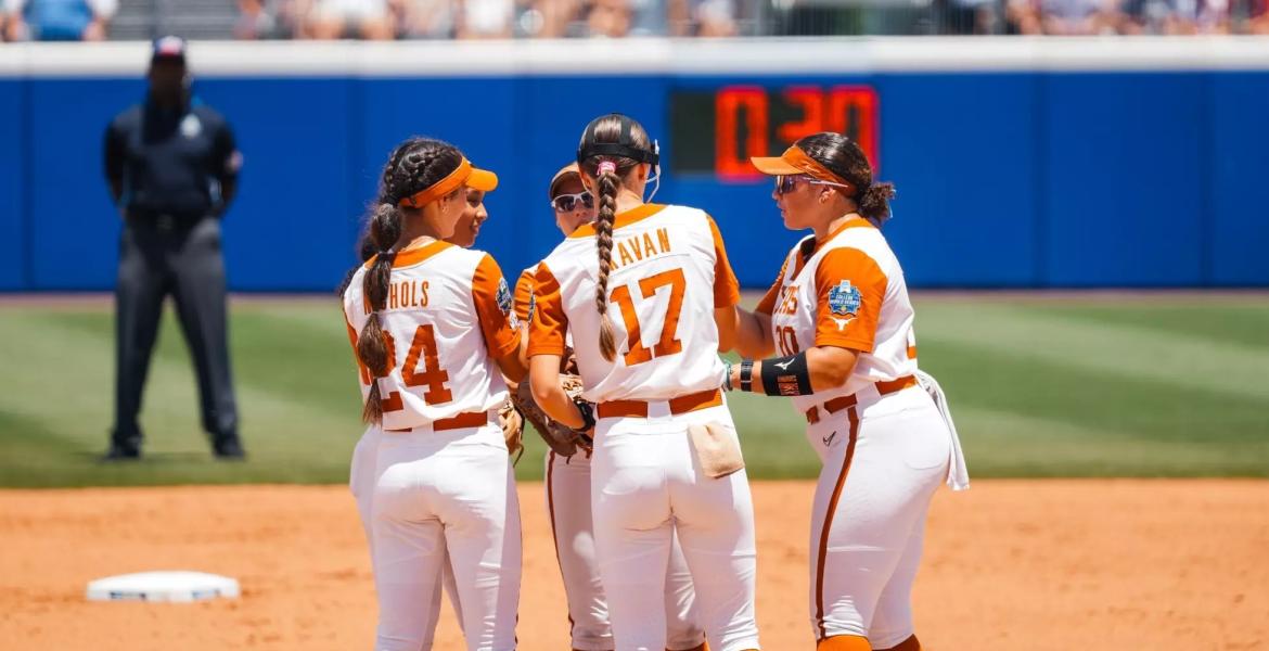 The Texas Longhorns softball team meets in the infield during the 2026 Women's College World Series.