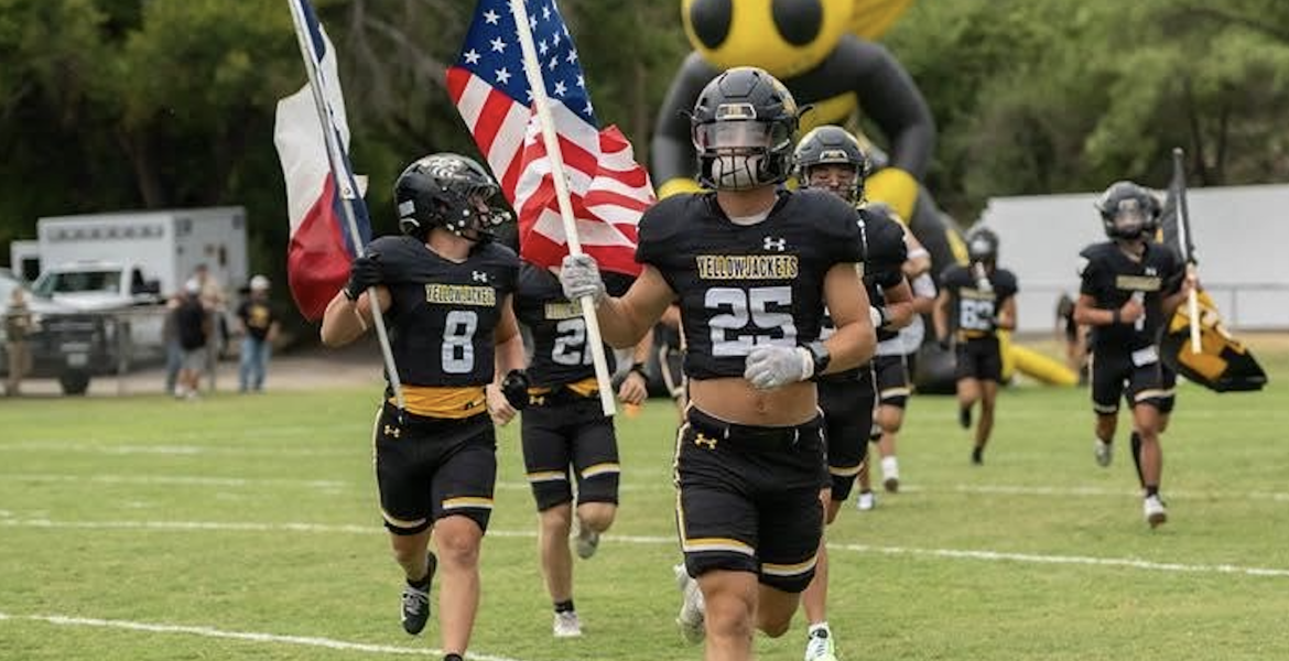 The Menard football team runs onto the field during the 2026 season.