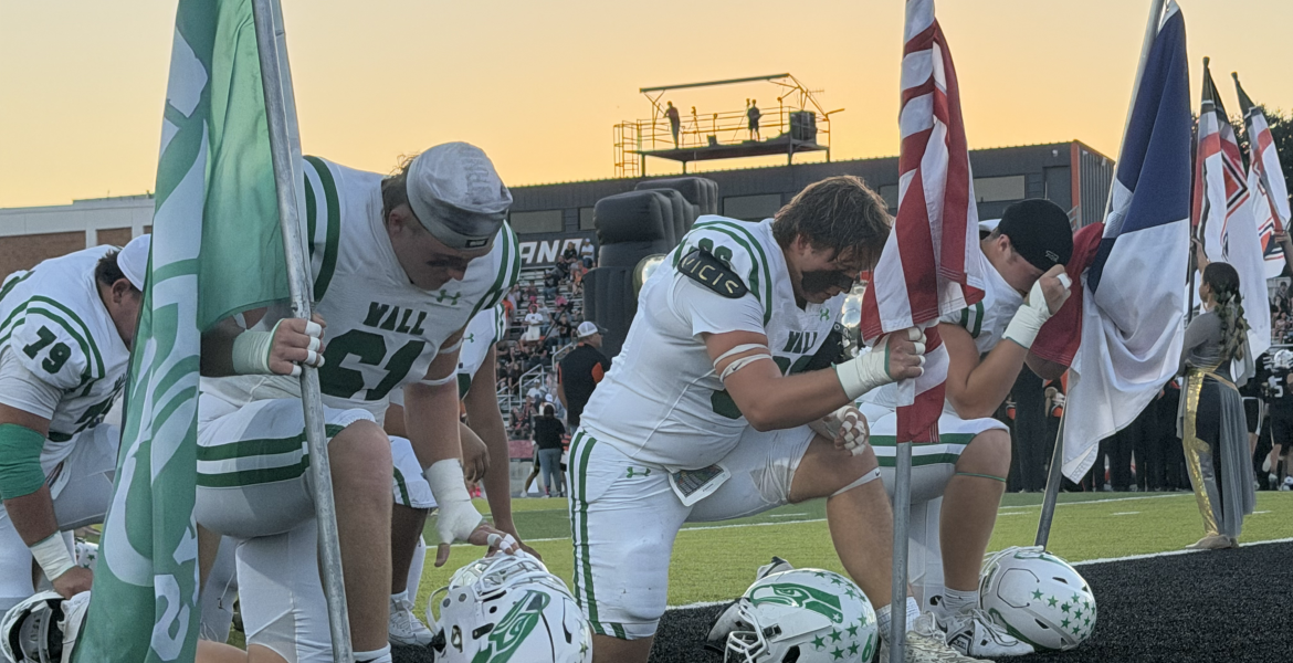 The Wall Hawks kneel before their game at Llano on Friday, Oct. 9, 2026.