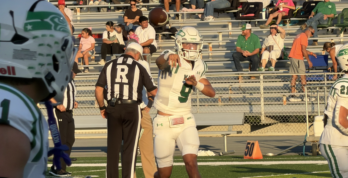 Wall quarterback Gunner King fires a pass in warmups before the Hawks' game against Llano on Friday, Oct. 9, 2026.
